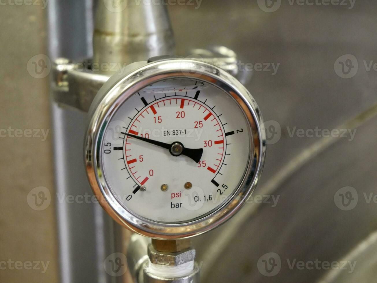 Pointer indicator of pressure on the industrial whiskey distiller construction, pipes and sensors, industrial production factory interior background photo