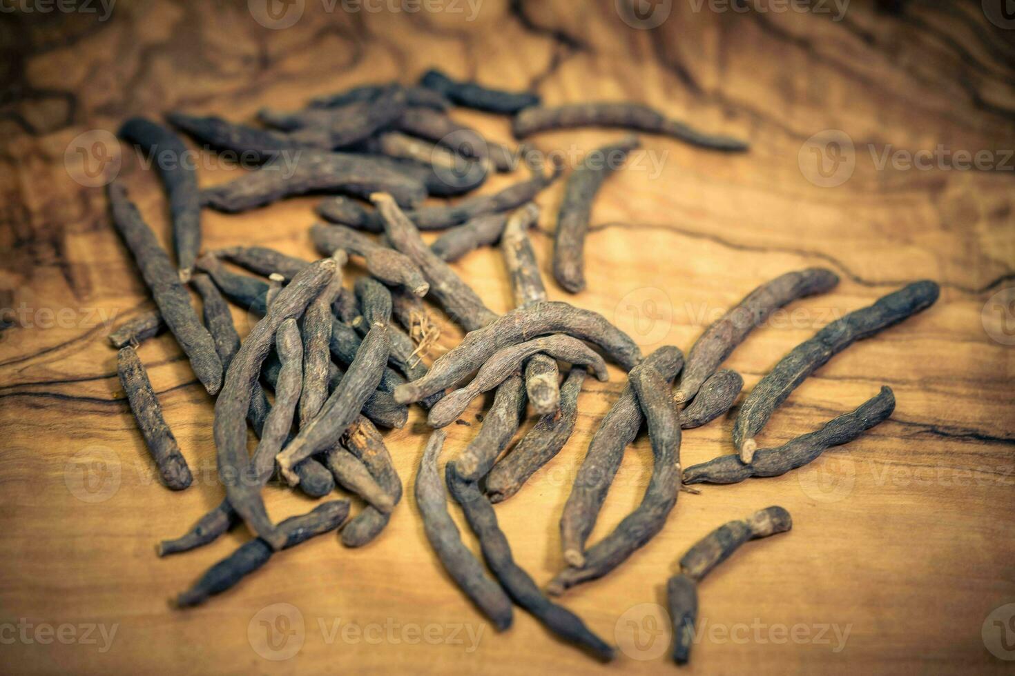 Black long pepper xylopia aethiopica on olive wood photo