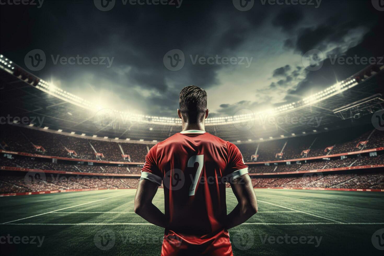 Rear view of football player in red jersey on stadium at night photo