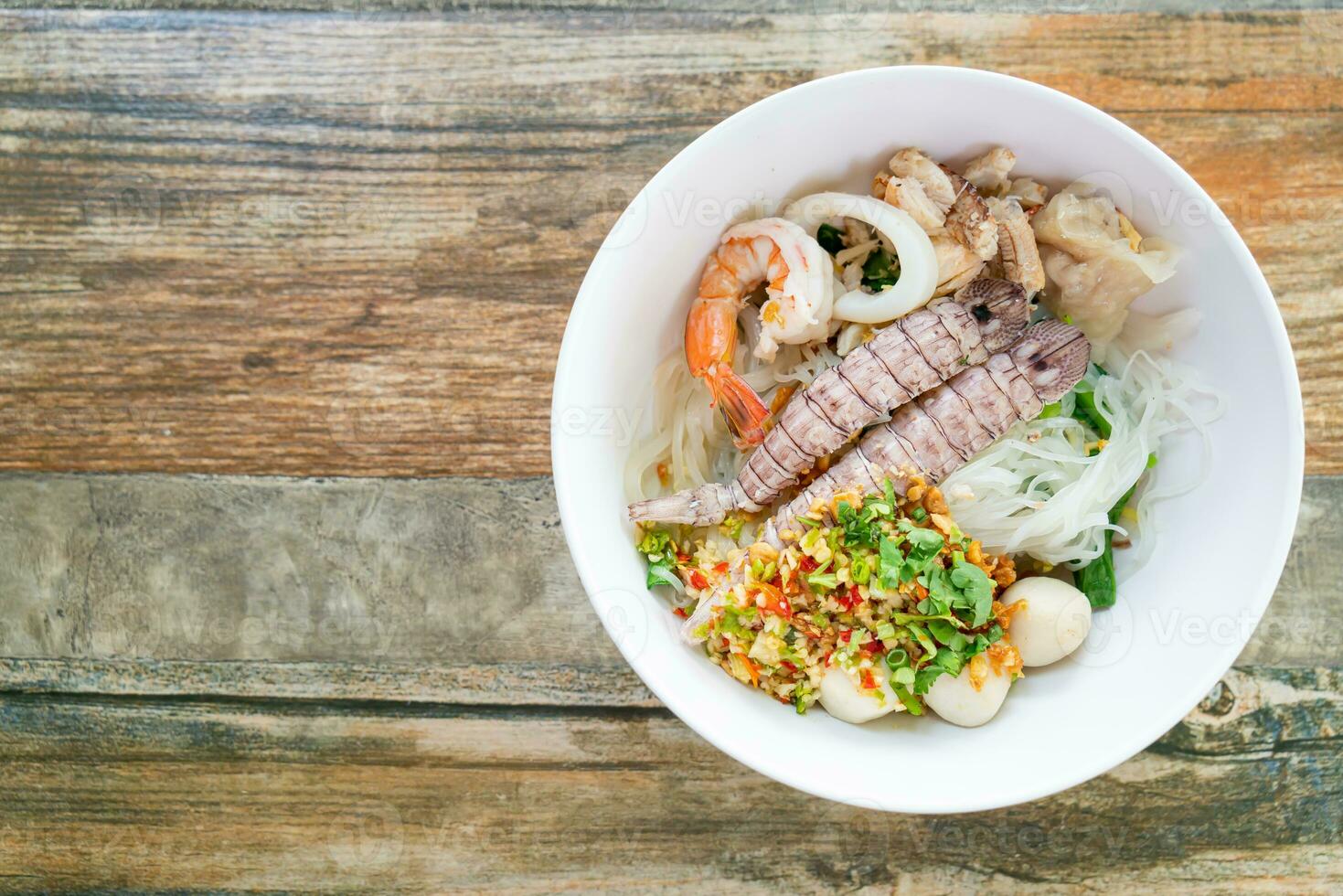 spicy seafood noodles bowl in Thai style photo