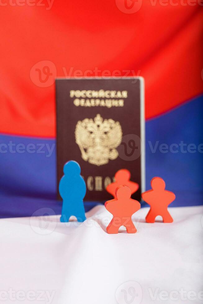 Russian Federation pass. Wooden figures on Russian flag. photo