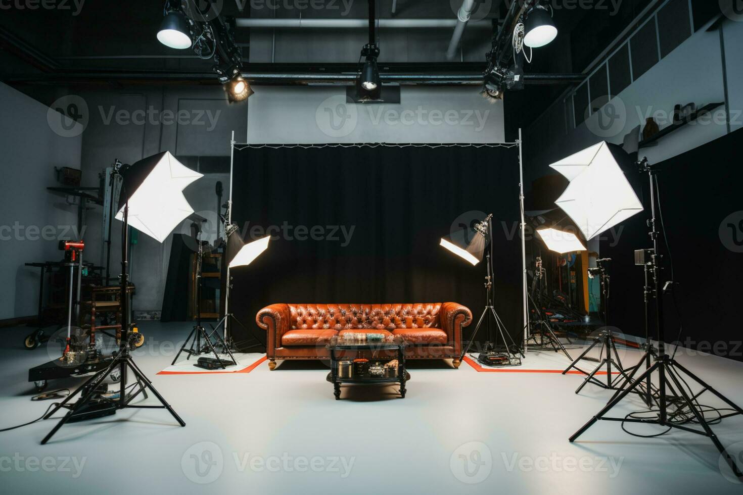 a photo studio with lighting equipment and a couch