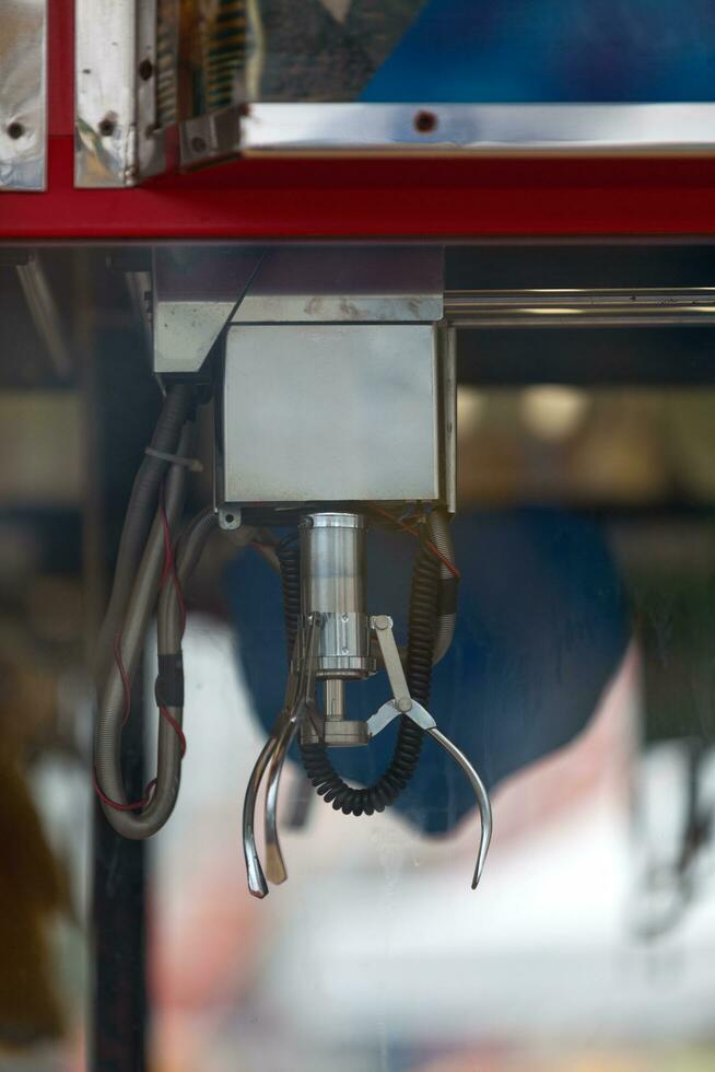 Claw of a toy crane of a traveling carnival photo