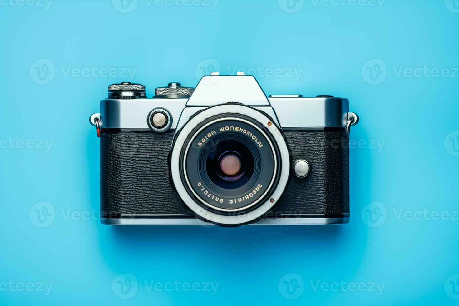 Vintage film camera on blue background. Top view with copy space photo