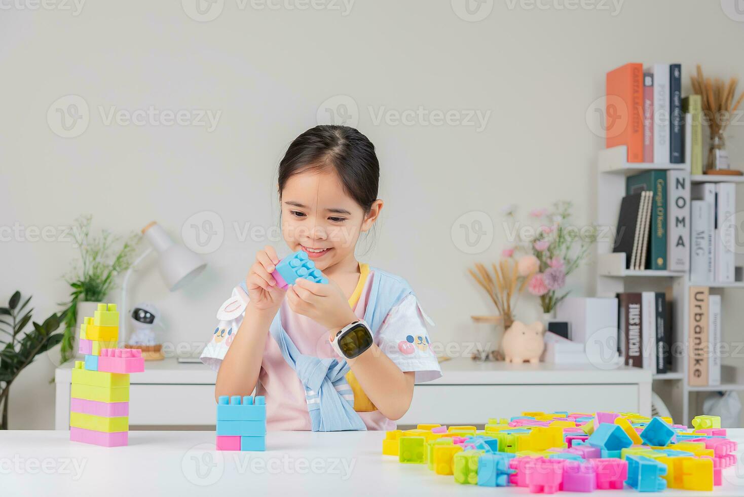 little girl is happy Playing colorful block puzzles. in the white room photo
