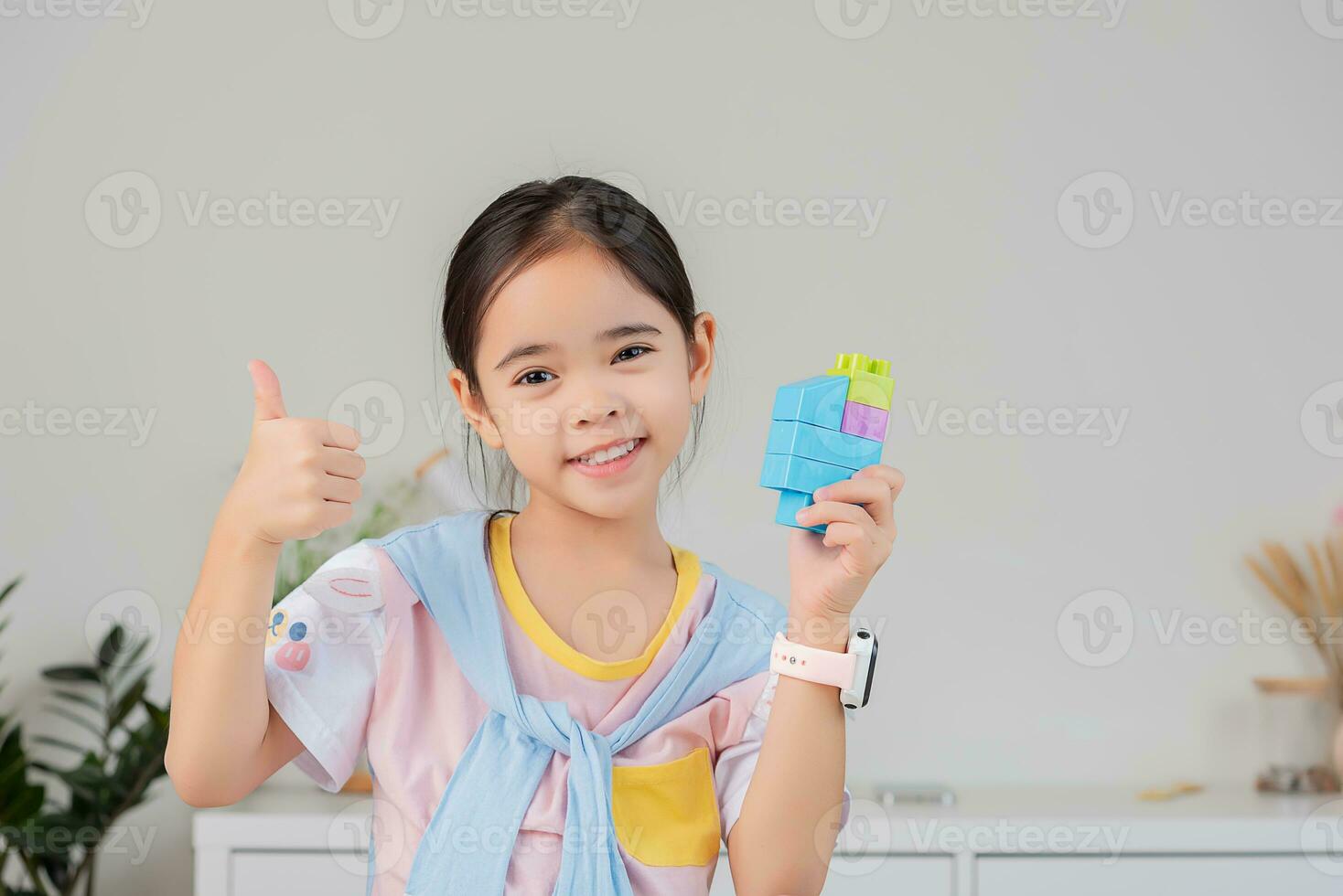little girl is happy Playing colorful block puzzles. in the white room photo