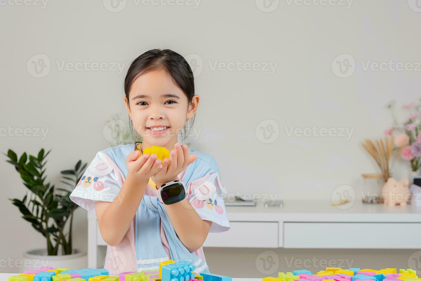 little girl is happy Playing colorful block puzzles. in the white room photo