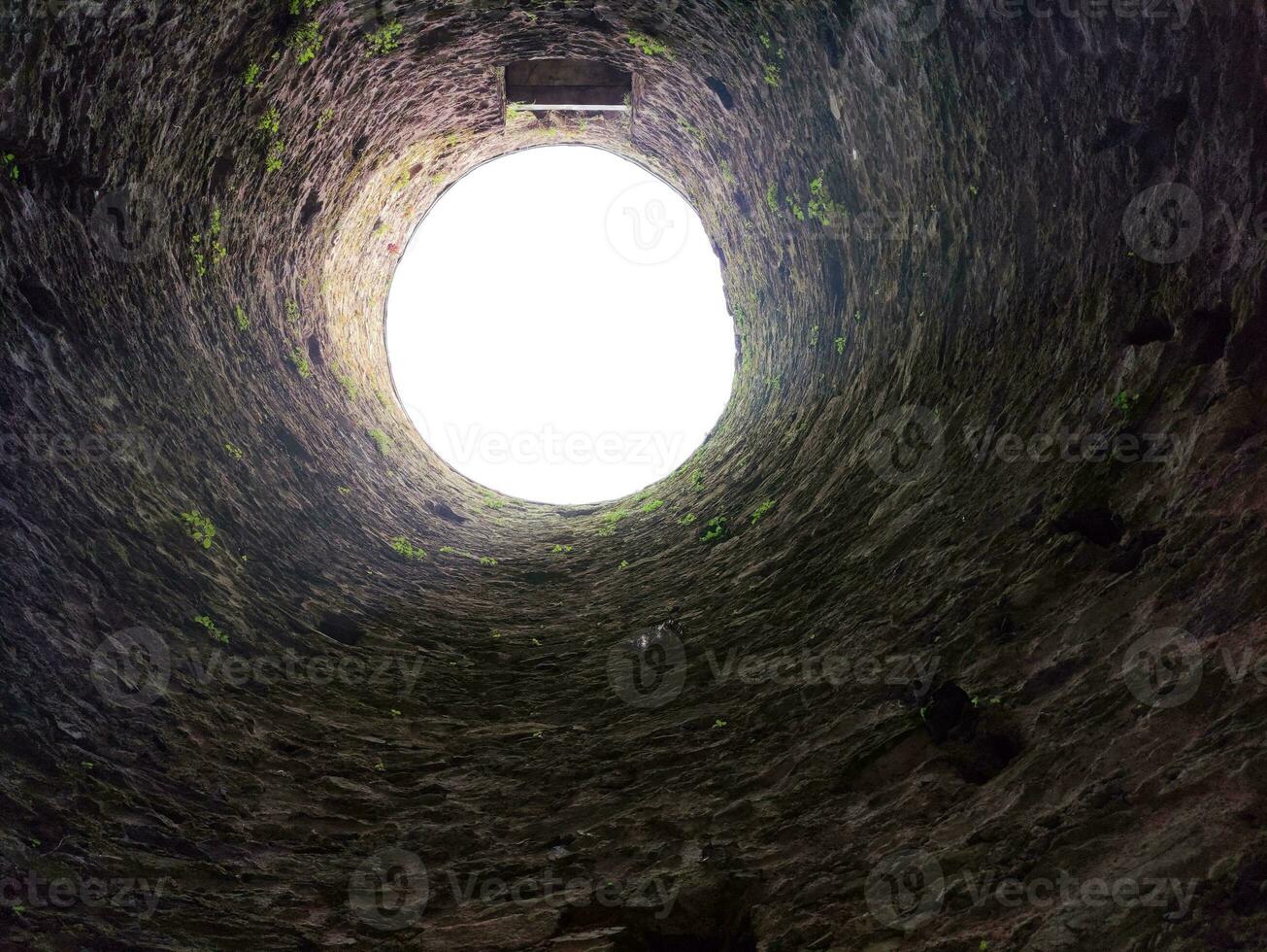 Stone well hole, old construction from inside, fall down in the well photo