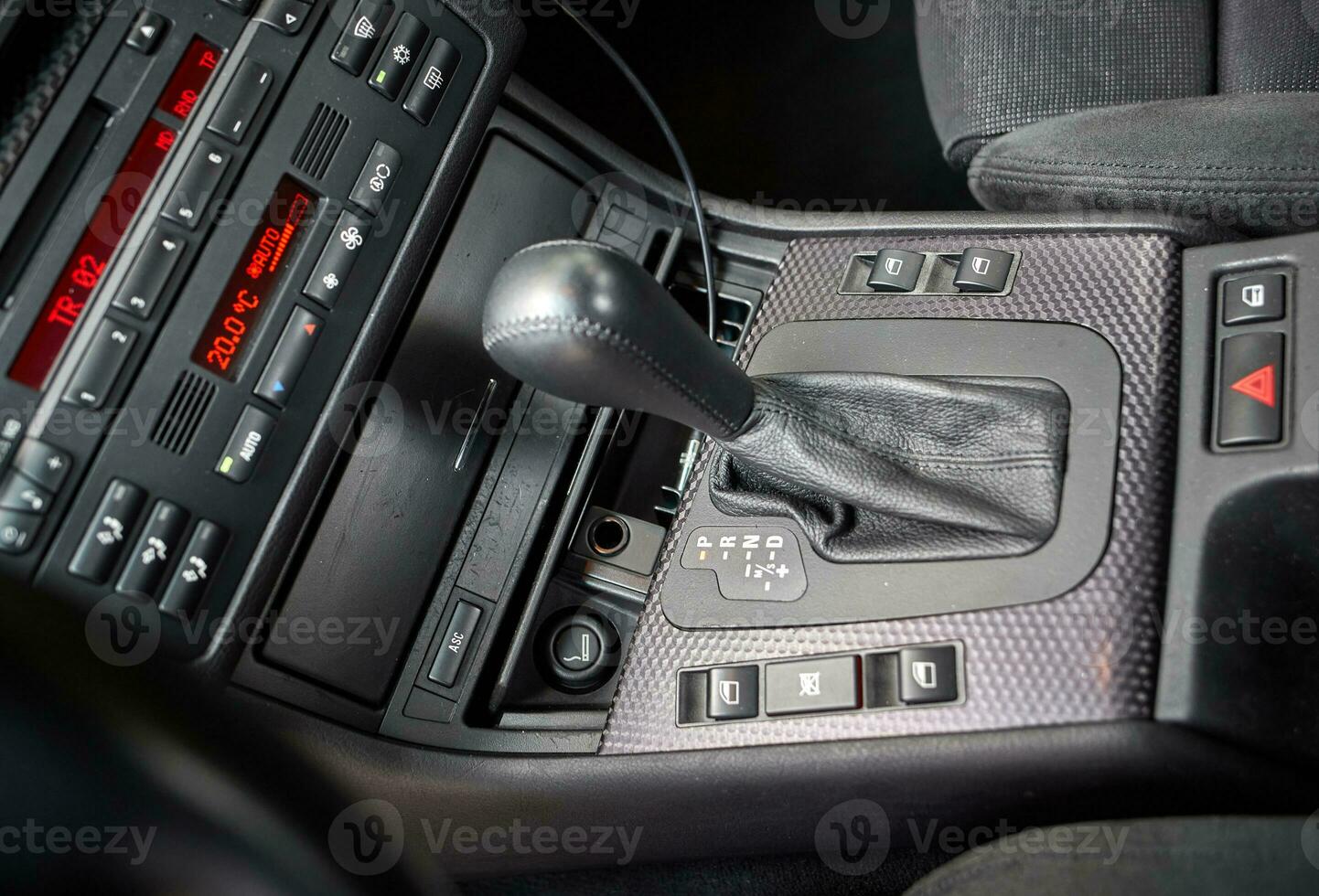 Shift lever, car steering wheel and sensors. Inside a modern car view, city car interior background photo