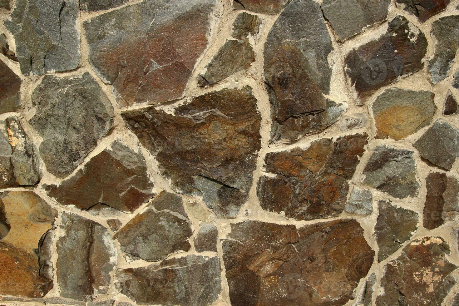 Stone texture made of different shape stones photo