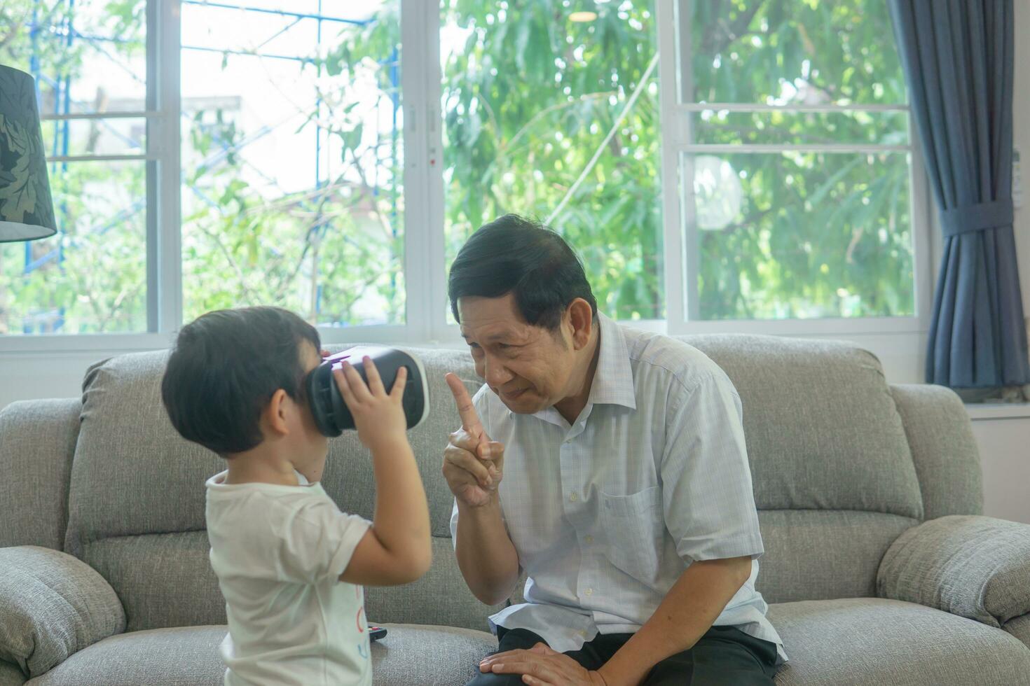 Grandfather and grandson playing vr game at home. photo