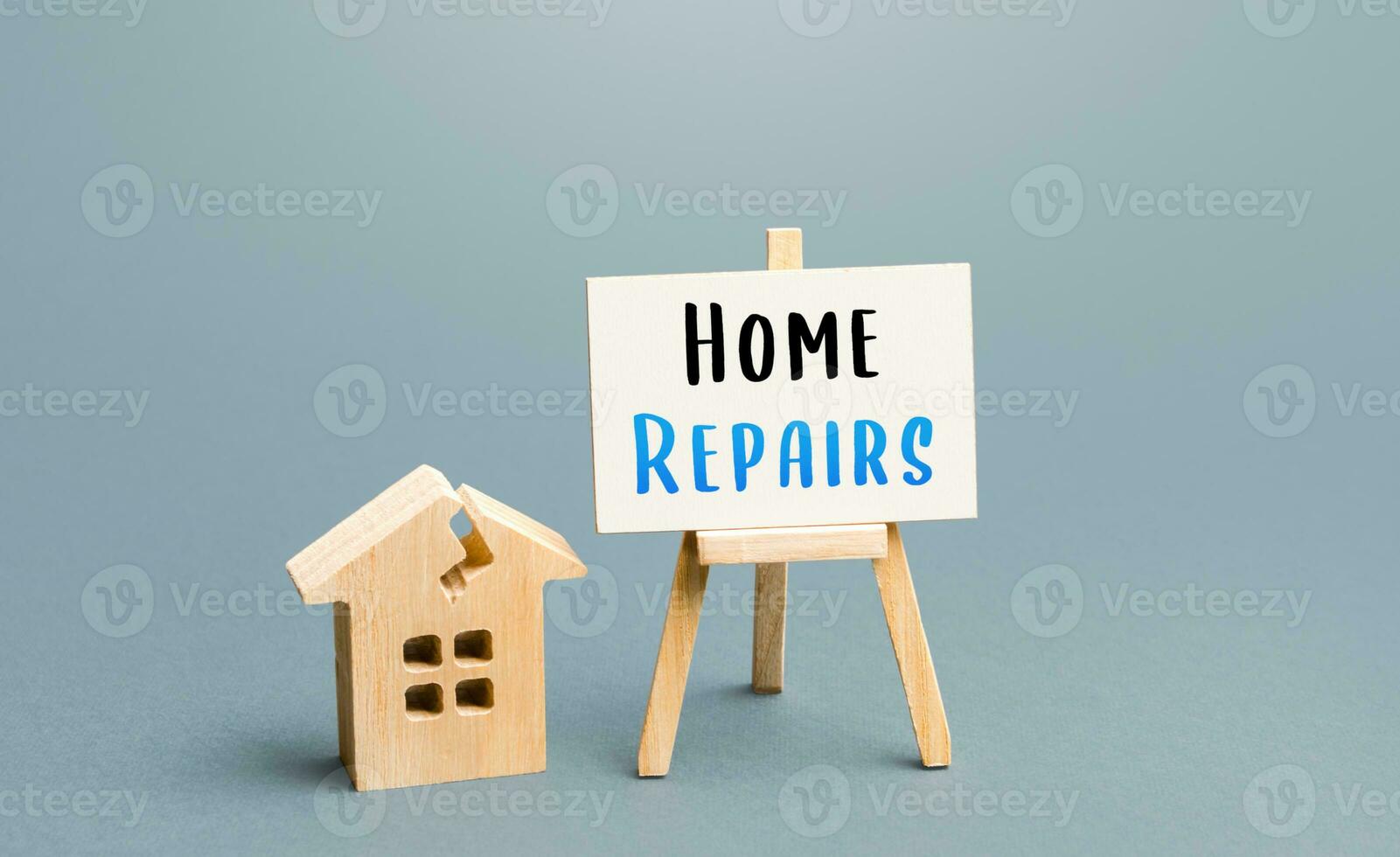 Cracked house and home repair sign. Restoration of the structure and elimination of damage. Renovation of old building. Property insurance. Reconstruction, repair of the facade. photo