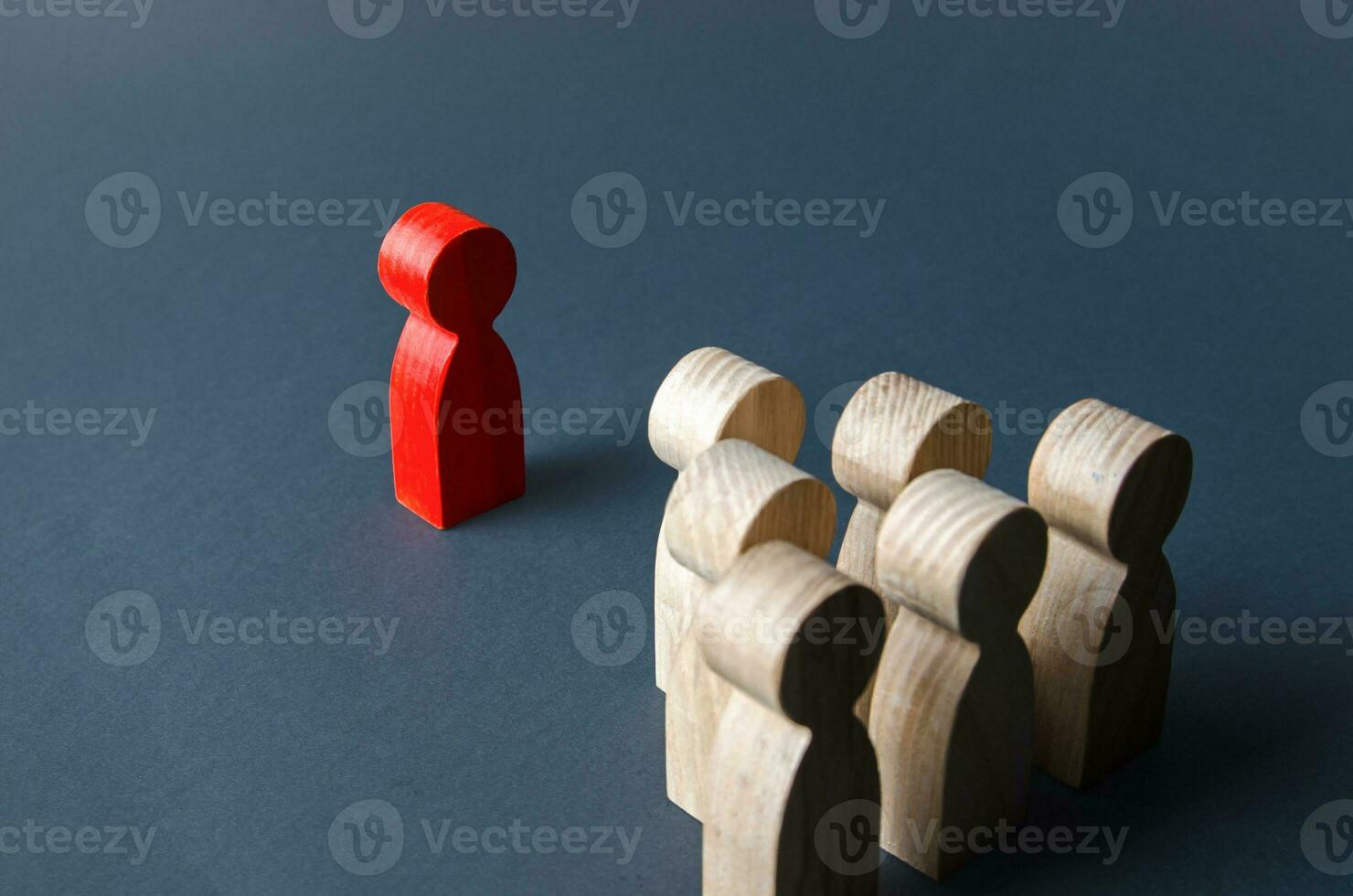 Red man and group of people. Leadership. Recognition of being a leader by team members. Establishing contact. Quantitative superiority. Cooperation against enemy. Dominance and headship, psychology. photo