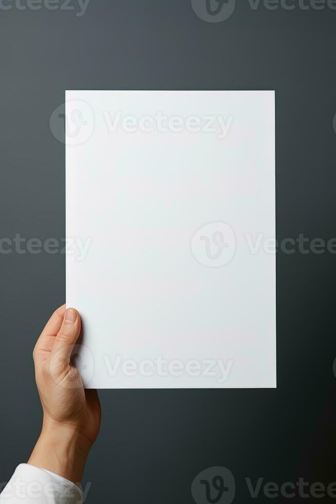 A human hand holding a blank sheet of white paper or card isolated on grey background. ai generated photo