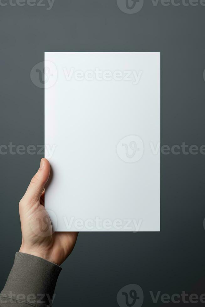 A human hand holding a blank sheet of white paper or card isolated on grey background. ai generated photo