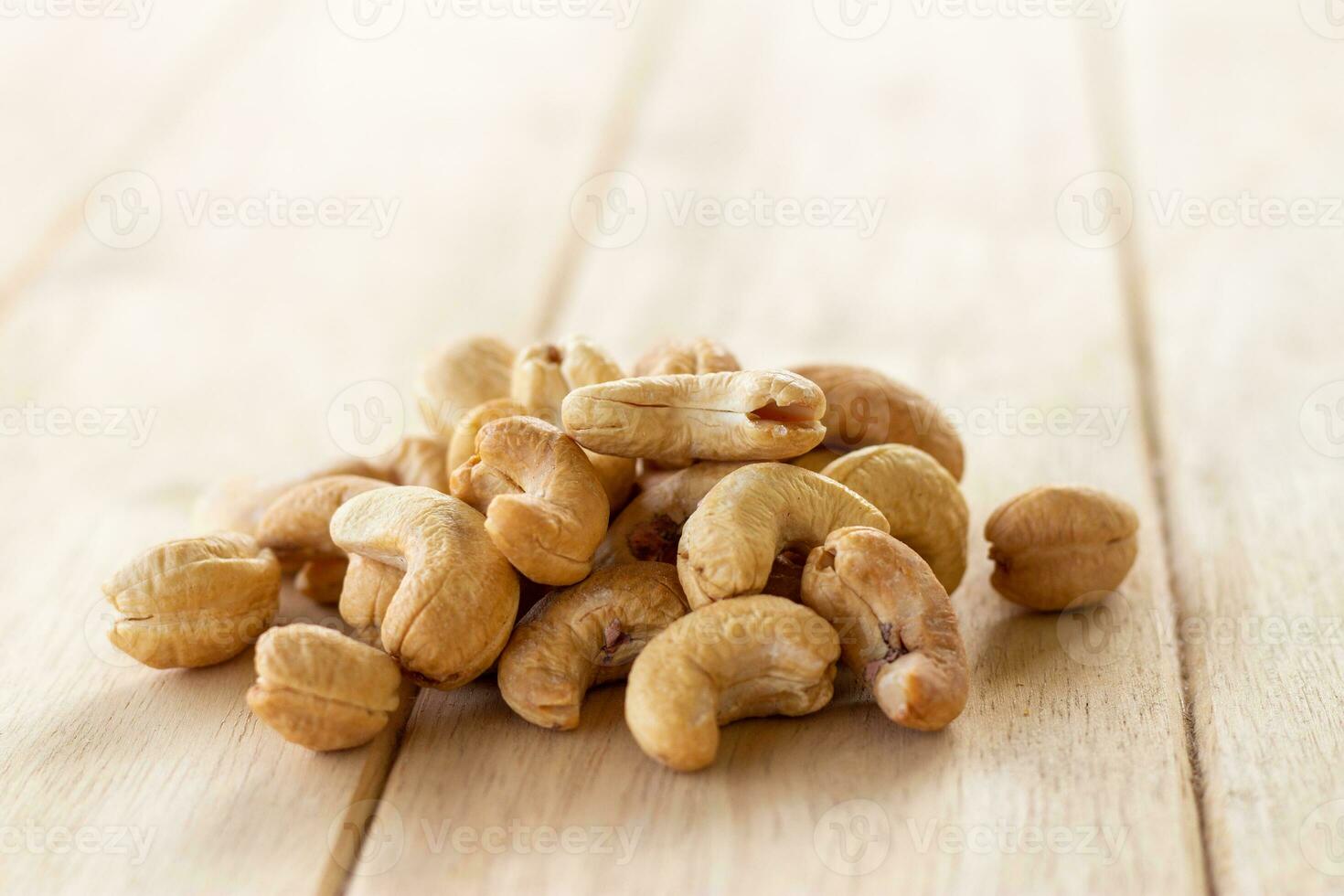 Many Roasted salted cashew nuts  on wooden background photo