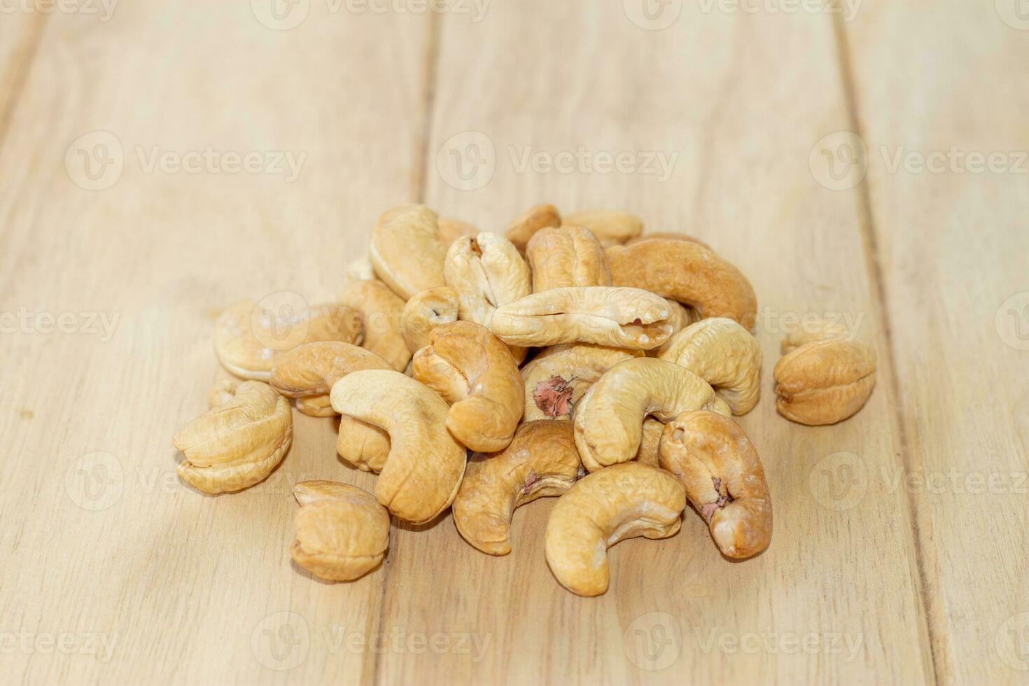 Many Roasted salted cashew nuts  on wooden background photo