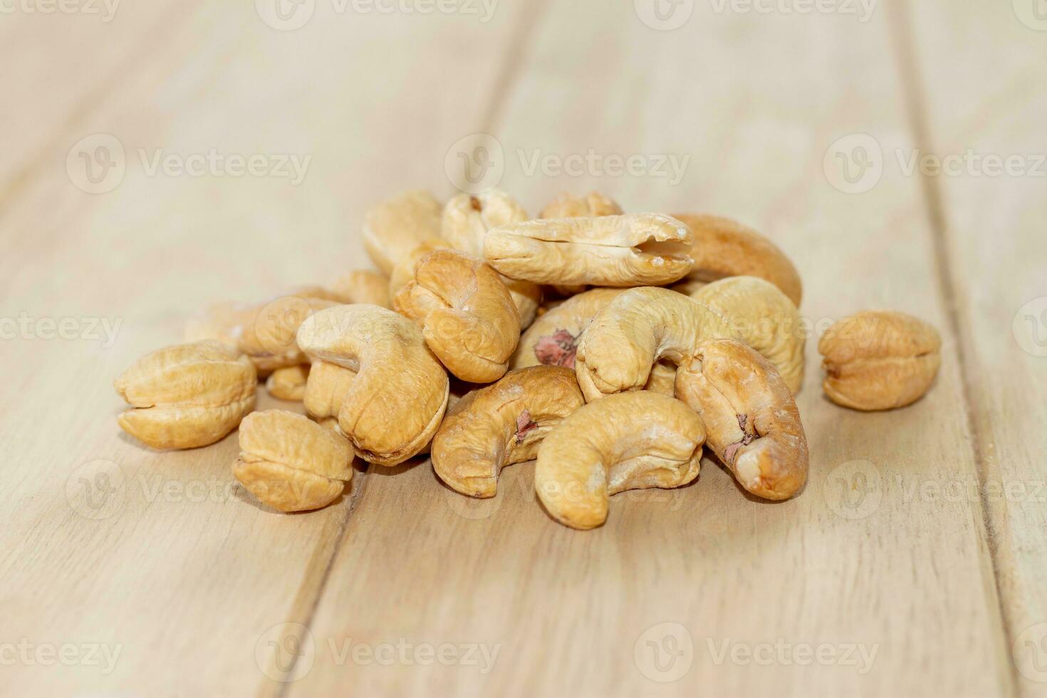 Many Roasted salted cashew nuts  on wooden background photo