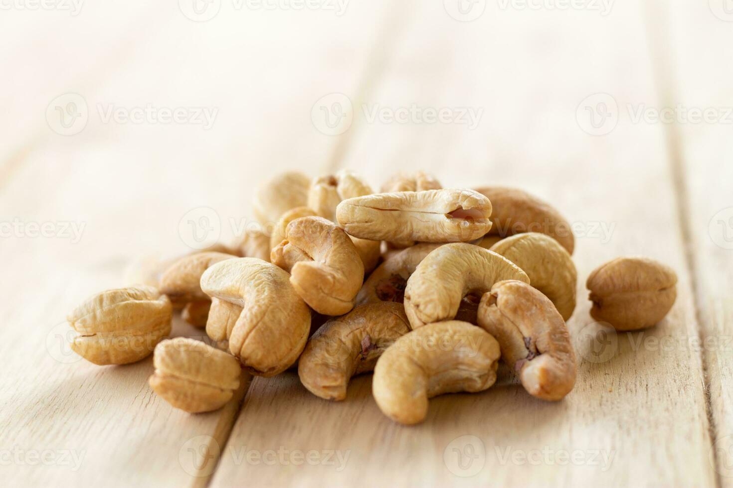 Many Roasted salted cashew nuts  on wooden background photo