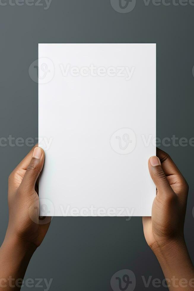 A human hand holding a blank sheet of white paper or card isolated on grey background. ai generated photo