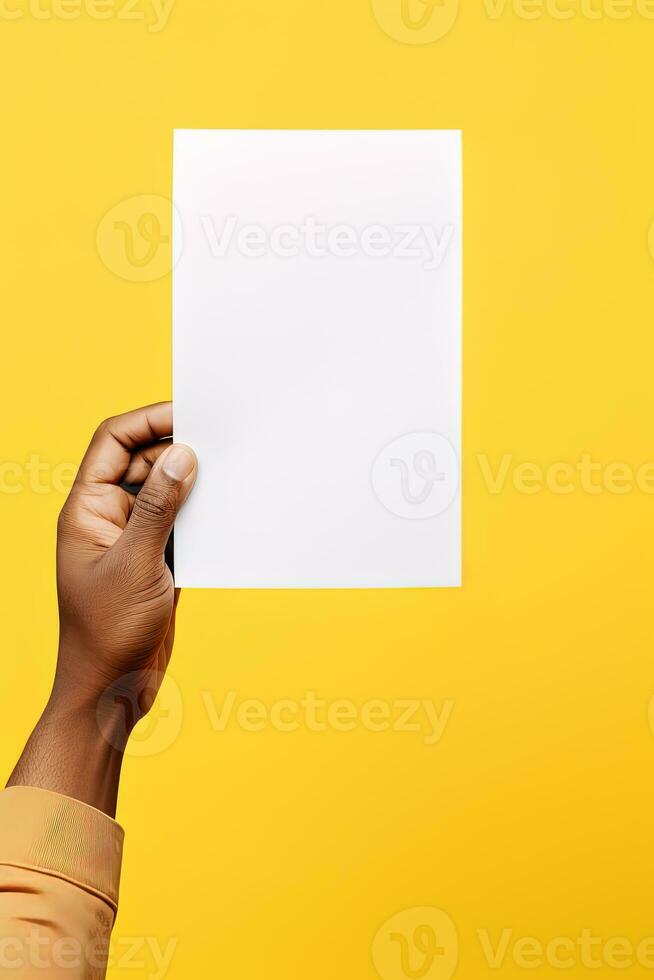 A human hand holding a blank sheet of white paper or card isolated on yellow background. ai generated photo
