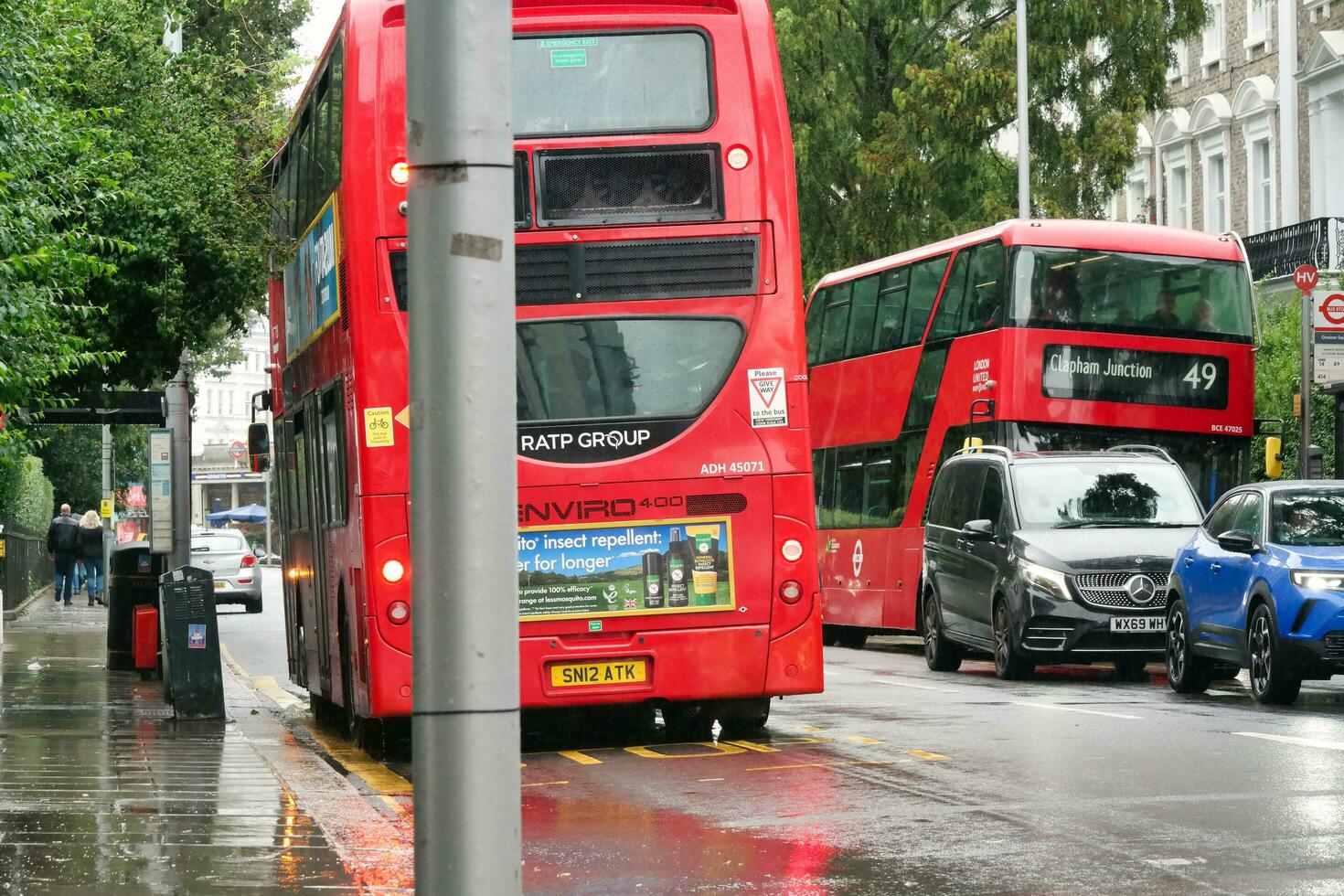 Gorgeous Low Angle view of Bus Service and British Traffic at Central London City of England UK. Image Captured on August 2nd, 2023 During Cloudy and Rainy Day. photo