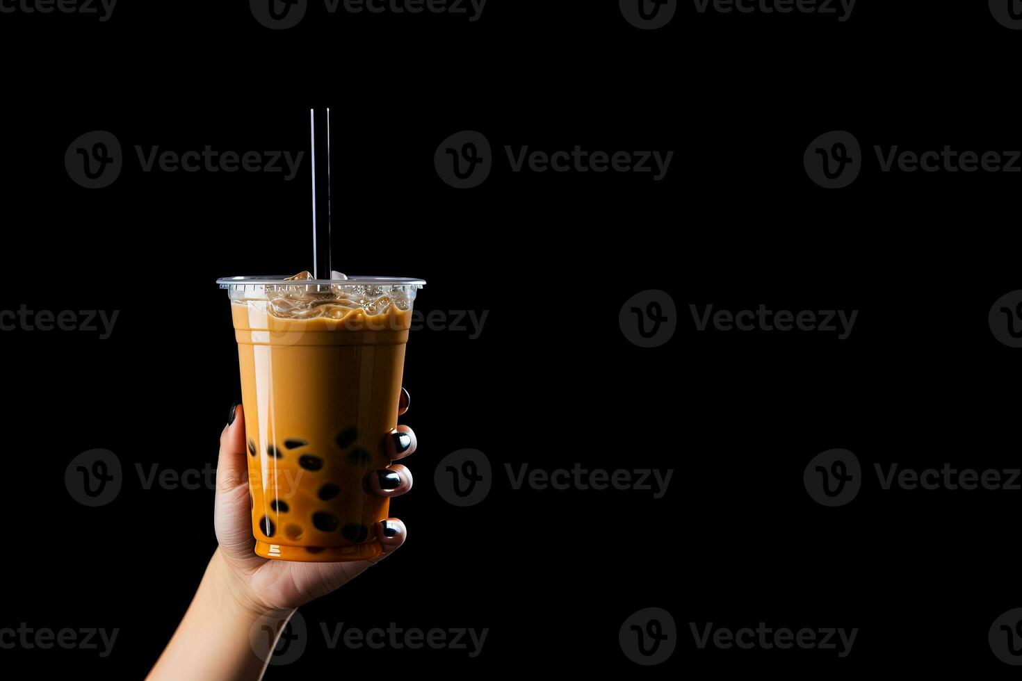 A hand holding takeaway plastic cup of delicious iced bubble milk tea and black pearls isolated on black background with copy space. ai generated photo