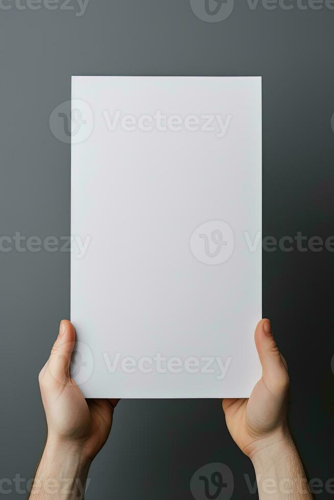 A human hand holding a blank sheet of white paper or card isolated on grey background. ai generated photo