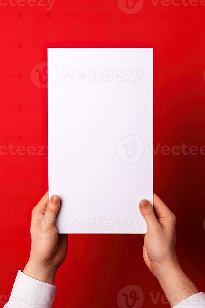 A human hand holding a blank sheet of white paper or card isolated on red background. ai generated photo