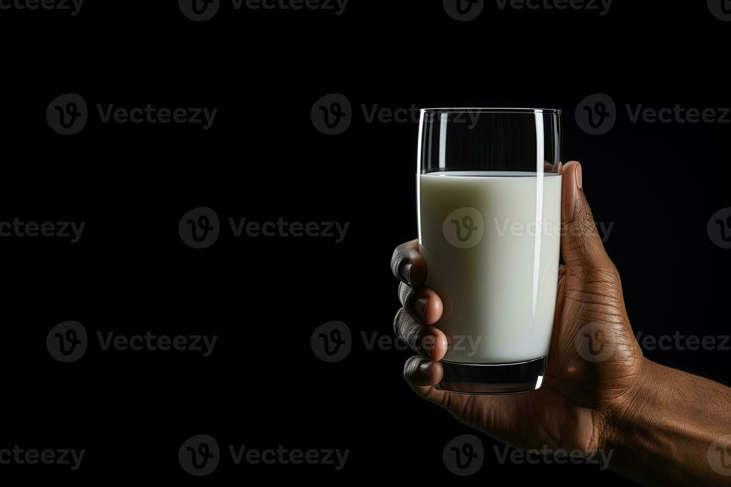 Hand holding a glass of fresh milk isolated on black background with copy space. ai generated photo