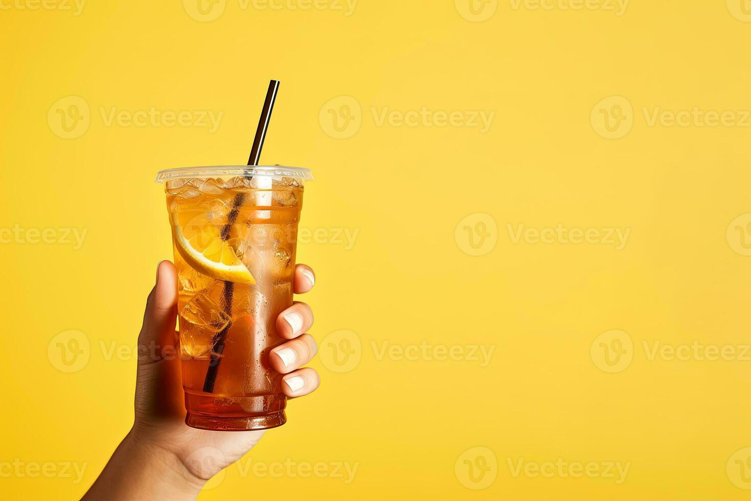 A hand holding takeaway plastic cup of delicious iced lemon tea isolated on yellow background with copy space. ai generated photo