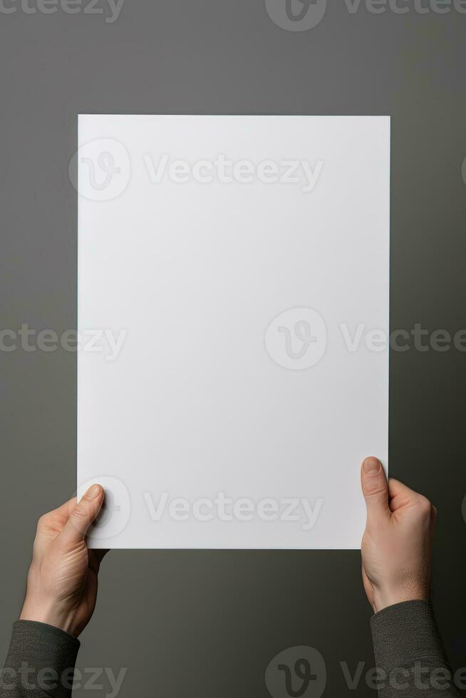 A human hand holding a blank sheet of white paper or card isolated on grey background. ai generated photo