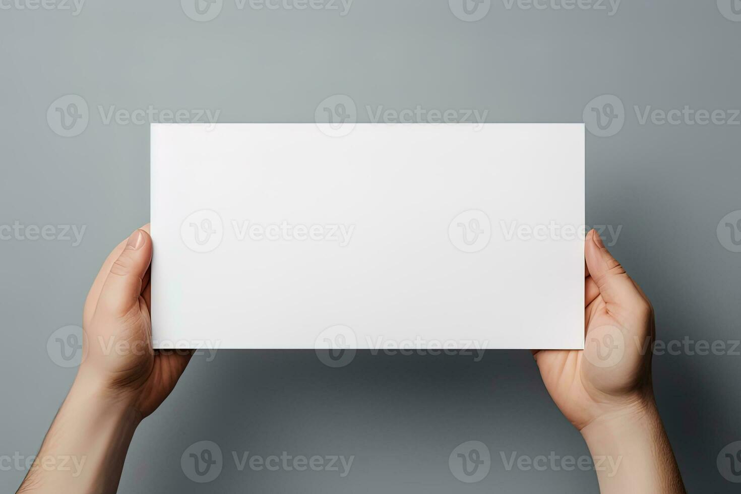 A human hand holding a blank sheet of white paper or card isolated on grey background. ai generated photo