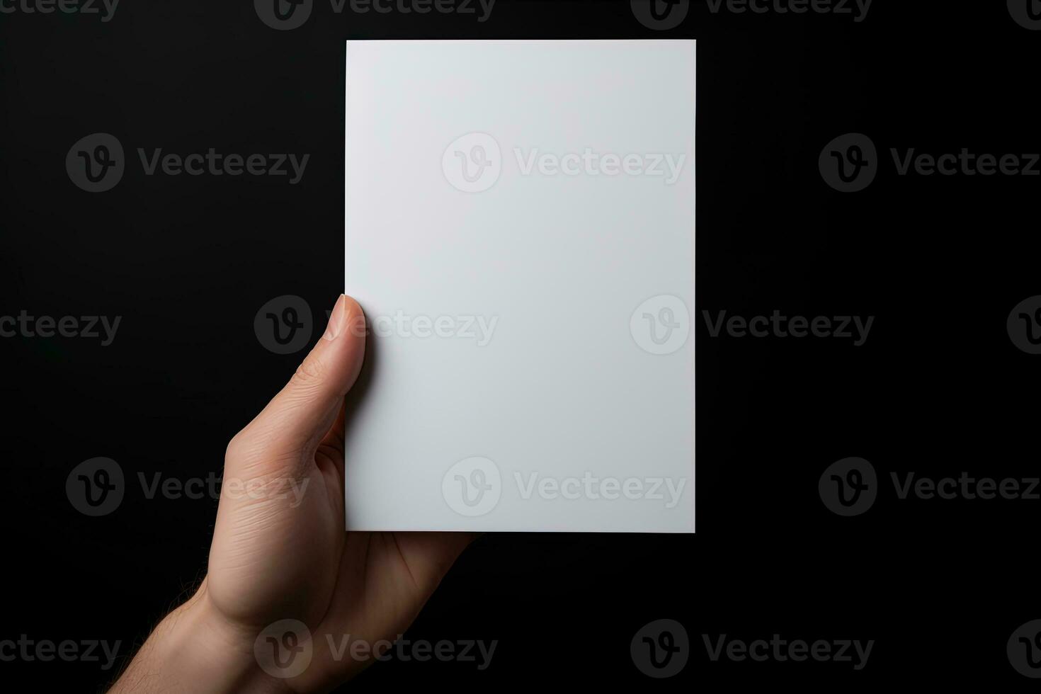 A human hand holding a blank sheet of white paper or card isolated on black background. ai generated photo