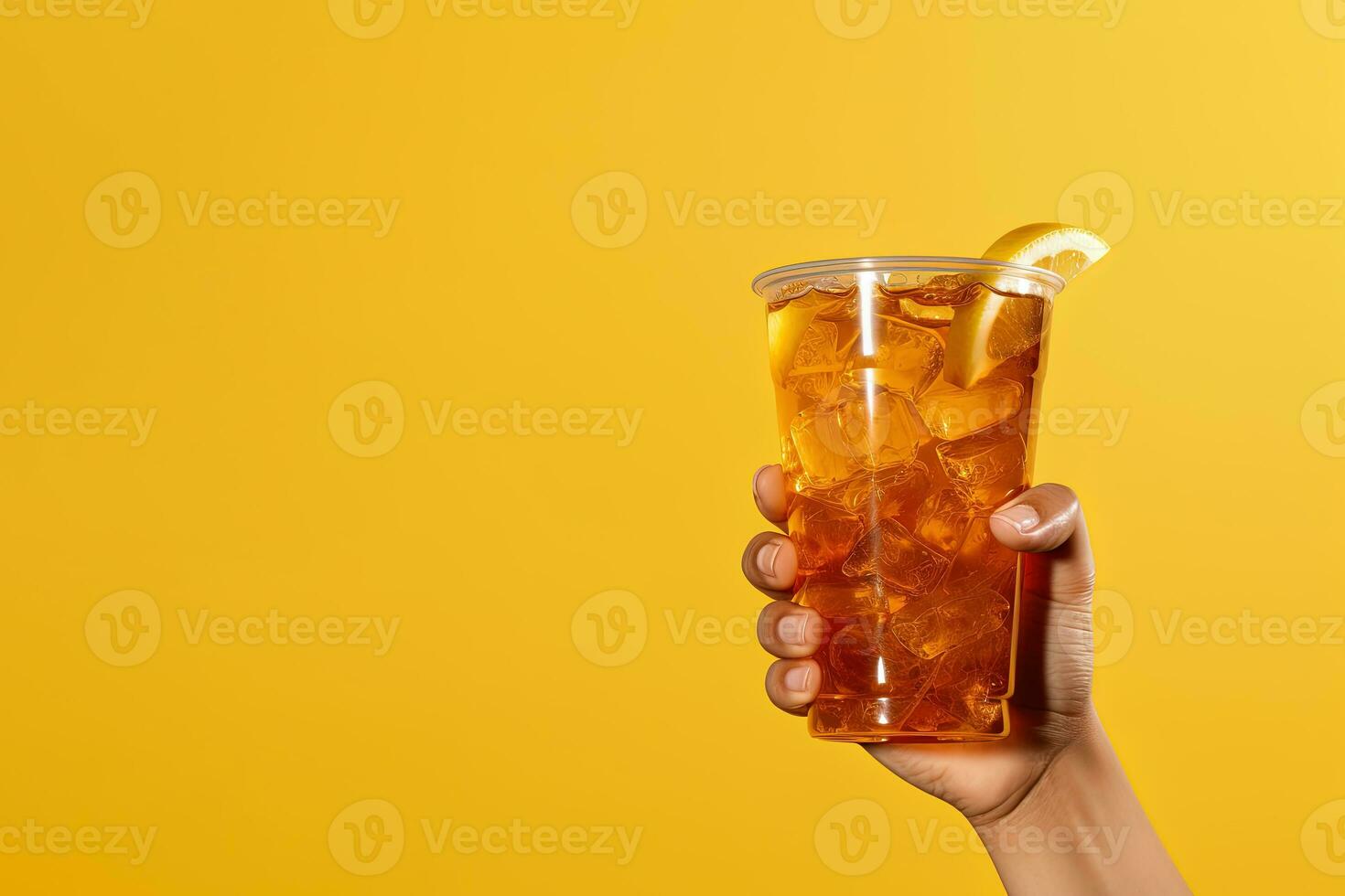 A hand holding takeaway plastic cup of delicious iced lemon tea isolated on yellow background with copy space. ai generated photo