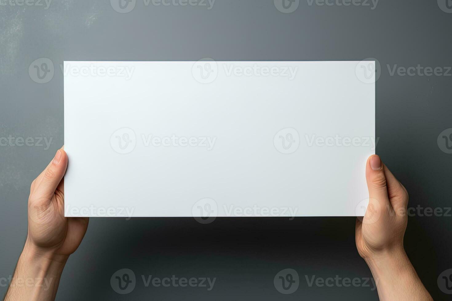 A human hand holding a blank sheet of white paper or card isolated on grey background. ai generated photo