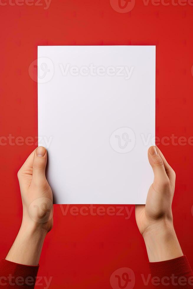 A human hand holding a blank sheet of white paper or card isolated on red background. ai generated photo