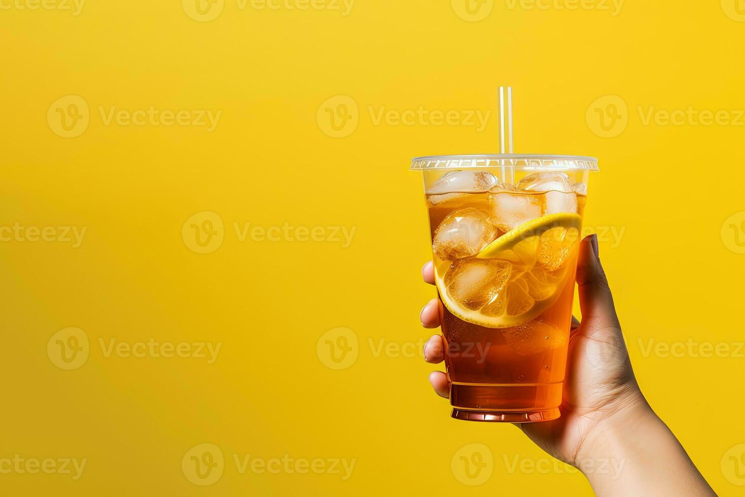 A hand holding takeaway plastic cup of delicious iced lemon tea isolated on yellow background with copy space. ai generated photo