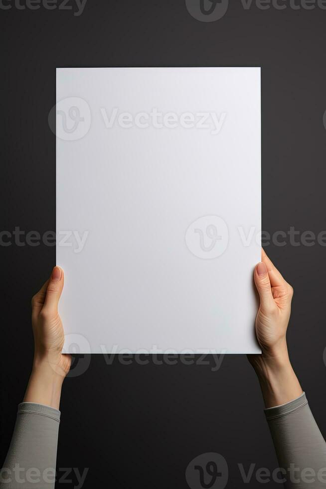 A human hand holding a blank sheet of white paper or card isolated on grey background. ai generated photo