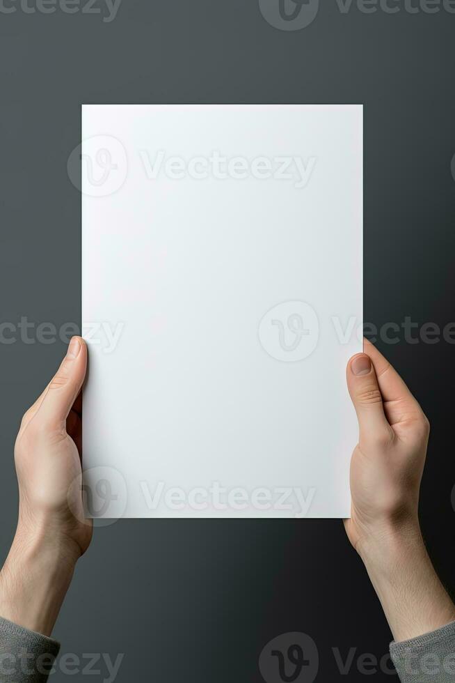 A human hand holding a blank sheet of white paper or card isolated on grey background. ai generated photo