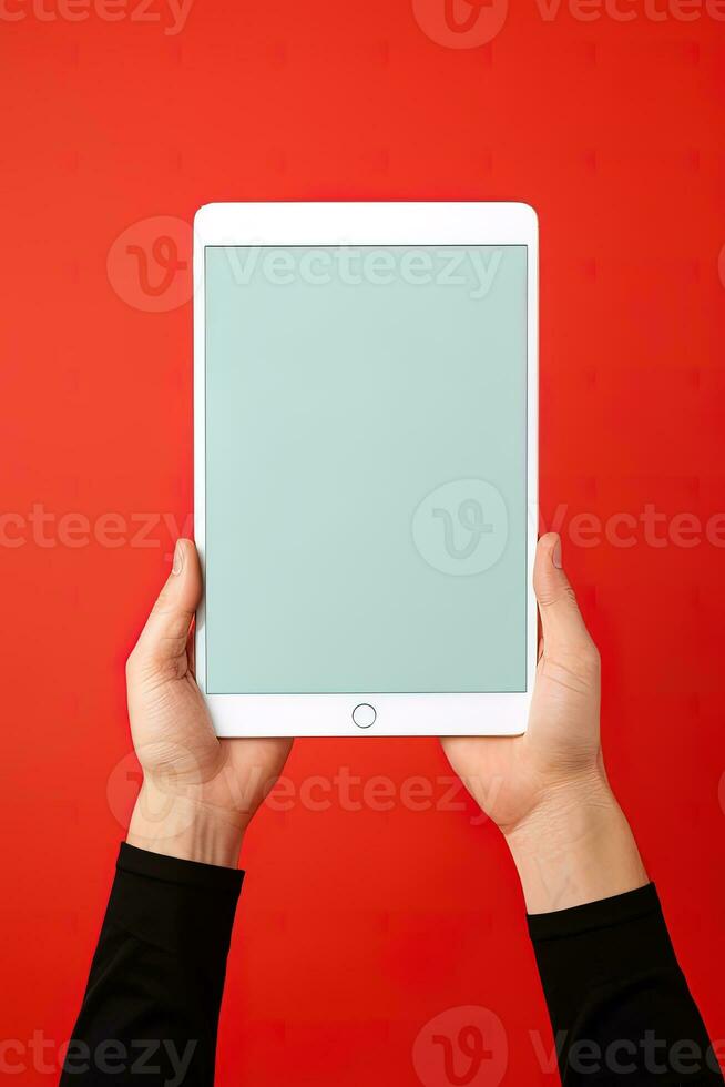 Hand holding tablet with mockup blank screen isolated on red background. ai generated photo