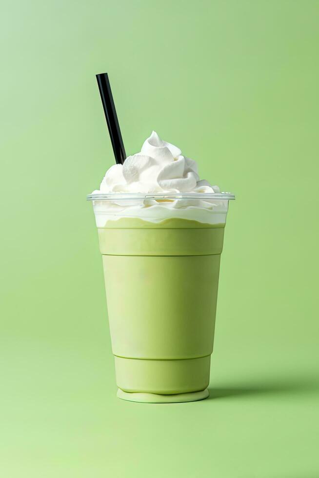 verde té frappucino con azotado crema en un para llevar taza aislado en verde antecedentes. ai generado foto