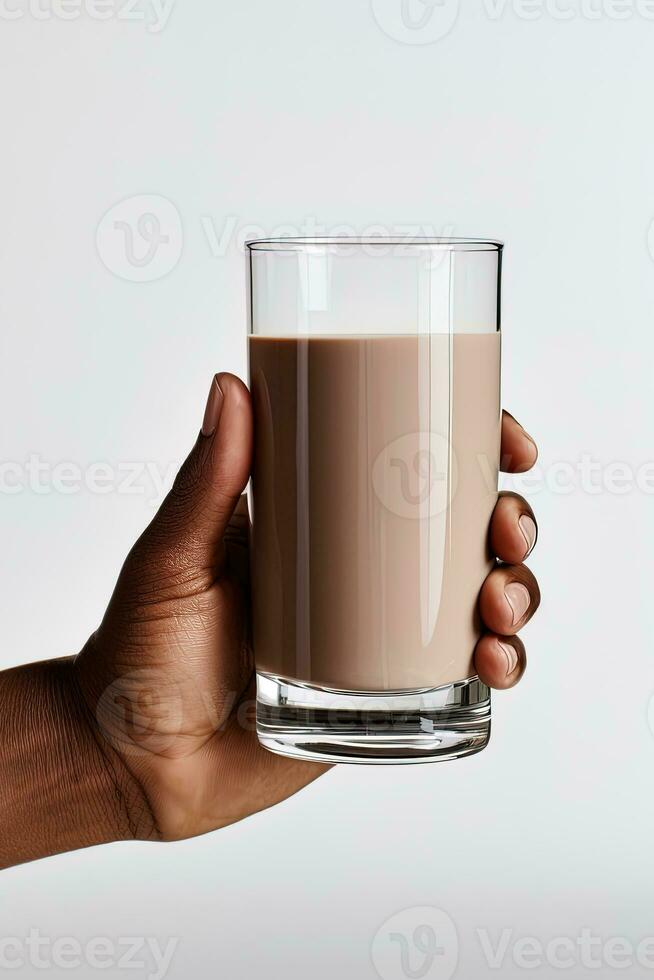 Hand holding a glass of delicious chocolate milk isolated on white background. ai generated photo