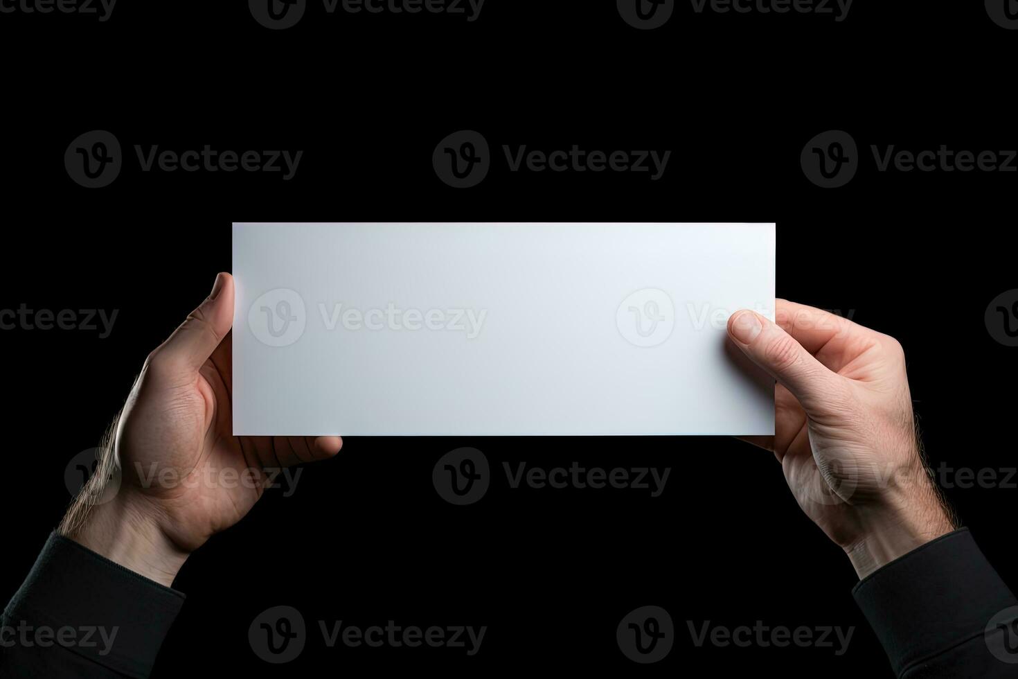A human hand holding a blank sheet of white paper or card isolated on black background. ai generated photo