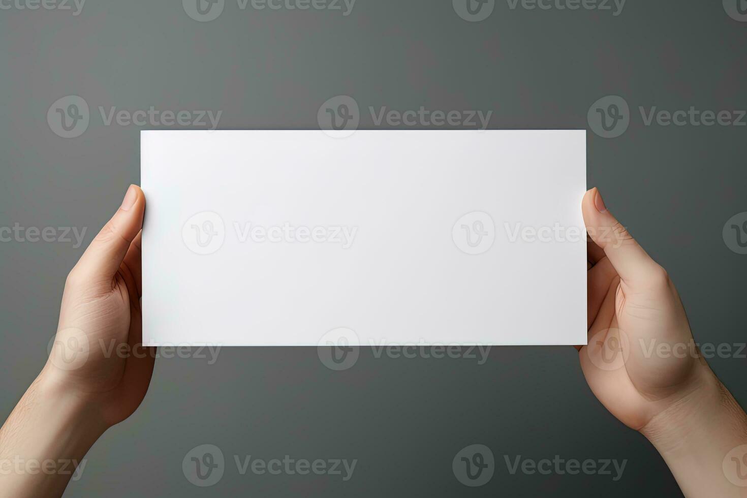A human hand holding a blank sheet of white paper or card isolated on grey background. ai generated photo