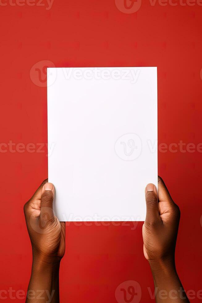 A human hand holding a blank sheet of white paper or card isolated on red background. ai generated photo