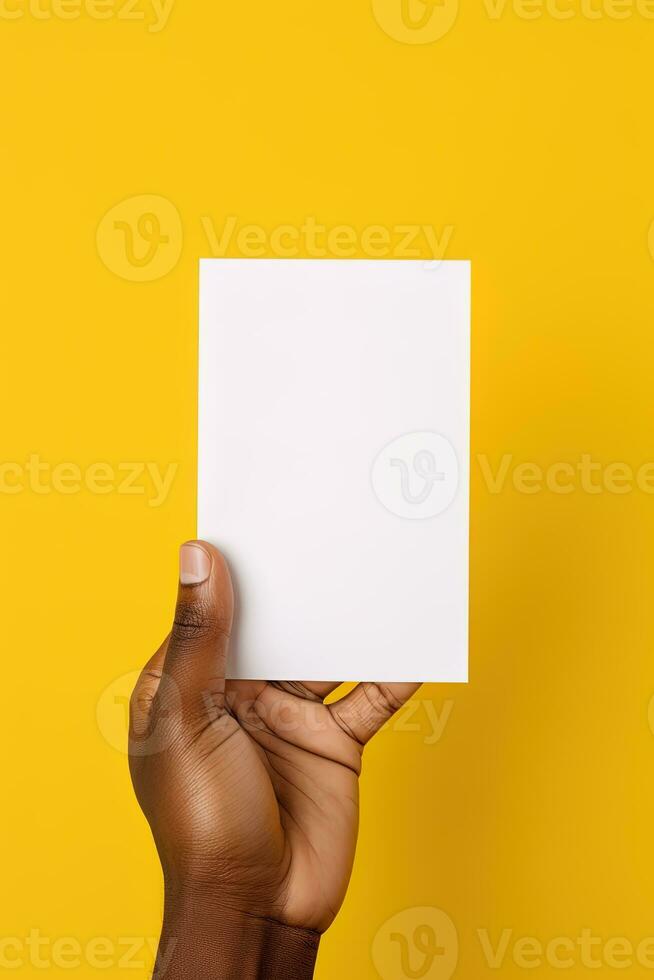 A human hand holding a blank sheet of white paper or card isolated on yellow background. ai generated photo