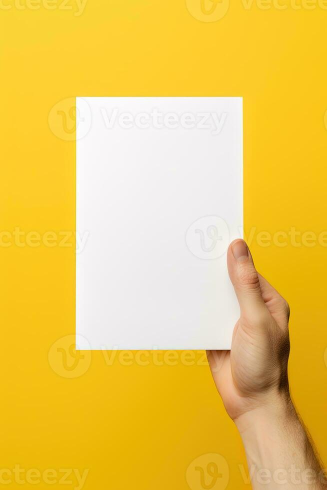 A human hand holding a blank sheet of white paper or card isolated on yellow background. ai generated photo