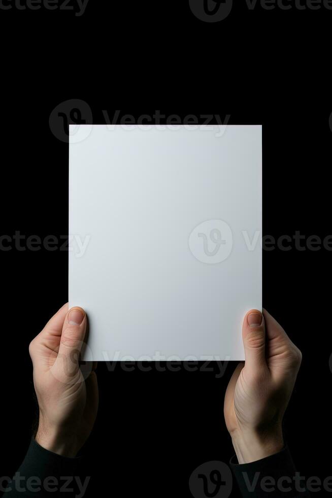 A human hand holding a blank sheet of white paper or card isolated on black background. ai generated photo