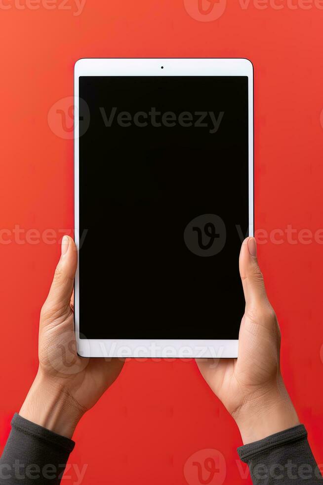 Hand holding tablet with mockup blank screen isolated on red background. ai generated photo